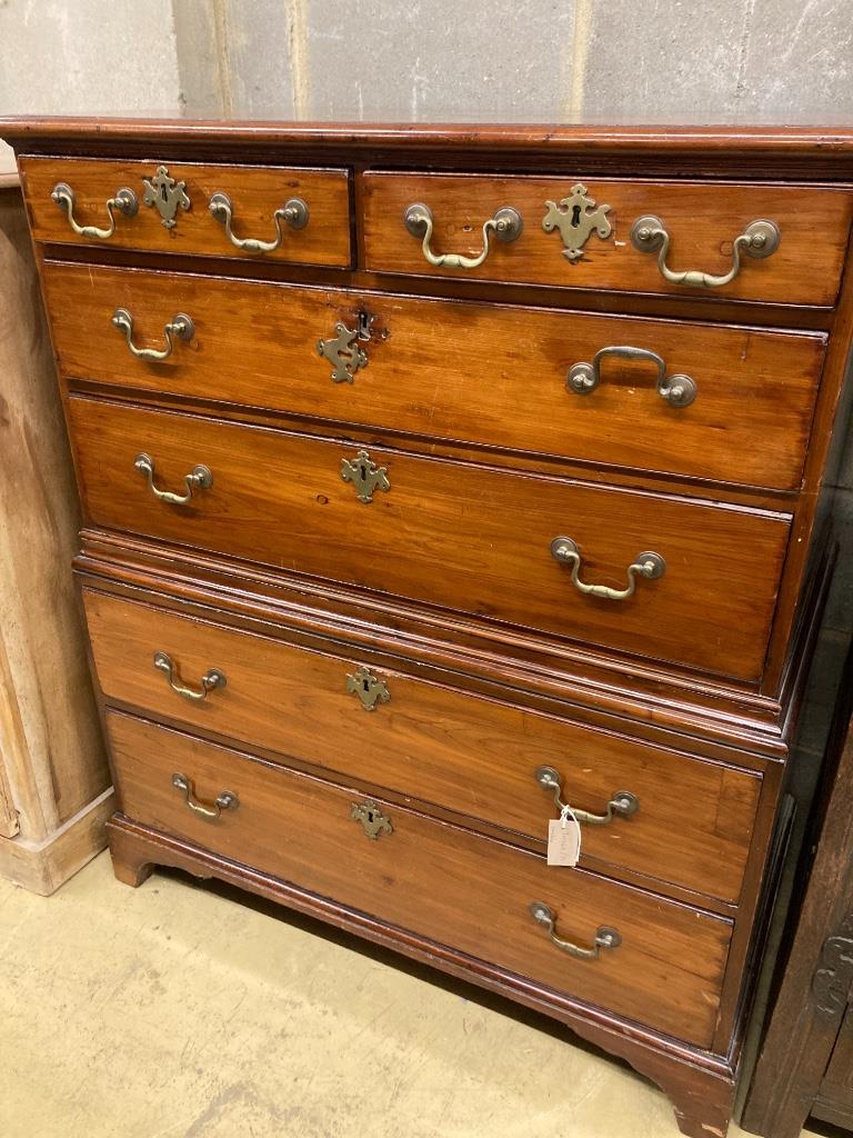 An early 19th century two part fruitwood chest